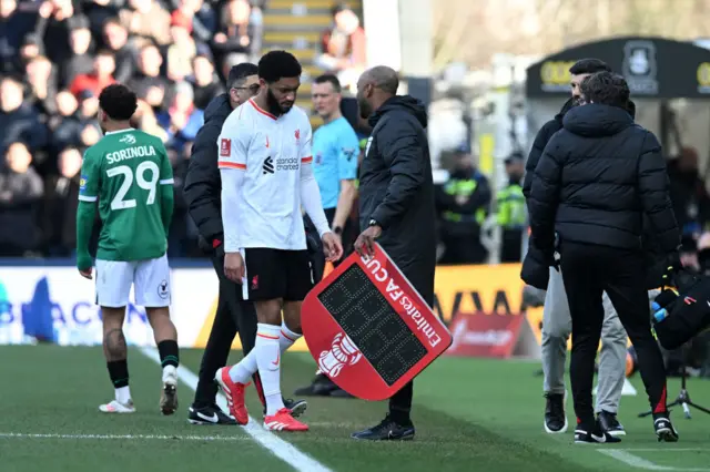 Joe Gomez of Liverpool looks dejected as he leaves the pitch with a injury