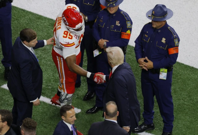 Trump shakes hands with Kansas City Chiefs' defensive tackle Chris EvansIvanka