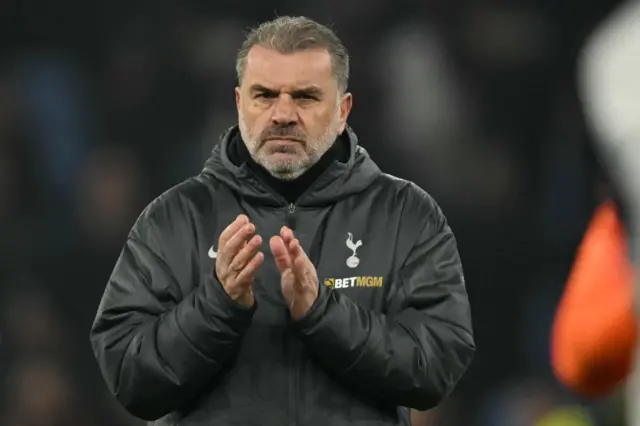 Ange Postecoglou applauds fans on the pitch