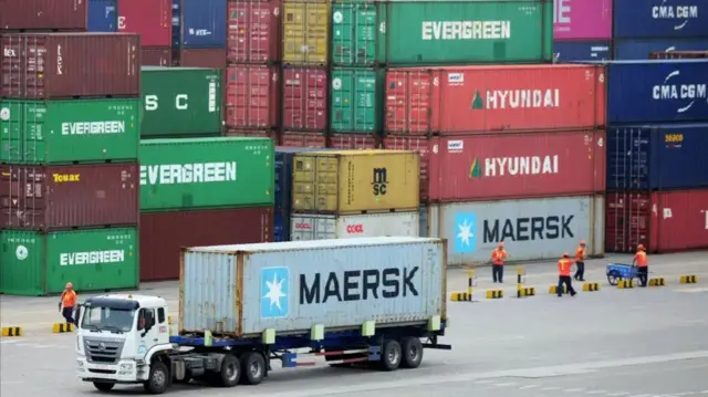 Large cargos are seen at a trade port, many of them with the logo Maersk, Evergreen and Hyundai