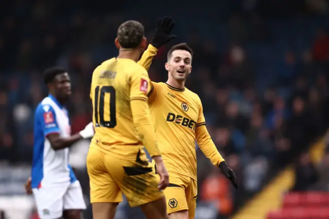 Pablo Sarabia of Wolverhampton Wanderers high fives teammate Matheus Cunha