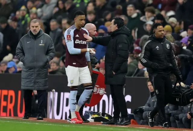 Ezri Konsa of Aston Villa walks past Unai Emery