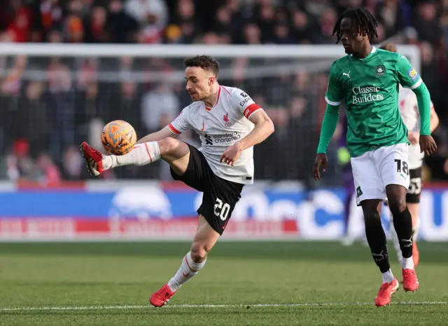 Liverpool's Diogo Jota in action with Plymouth Argyle's Darko Gyabi