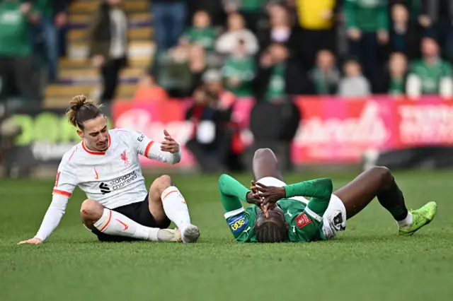 Mustapha Bundu of Plymouth Argyle reacts after being challenged by Kostas Tsimikas