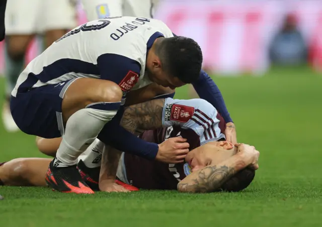 Tottenham Hotspur's Pedro Porro checks on Aston Villa's Lucas Digne after sustaining an injury