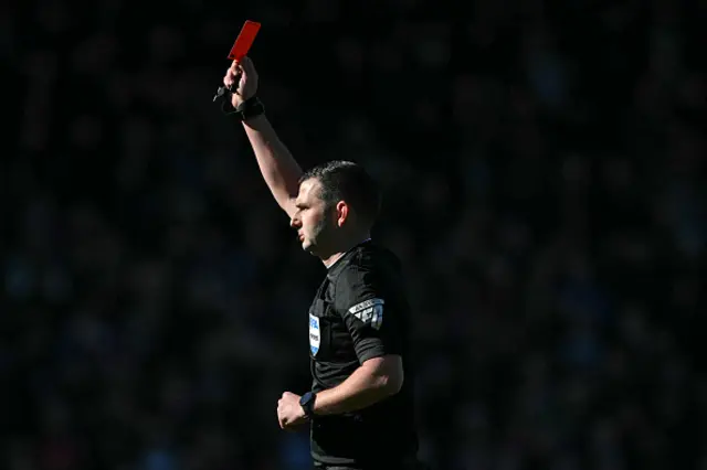 English referee Michael Oliver shows a red card