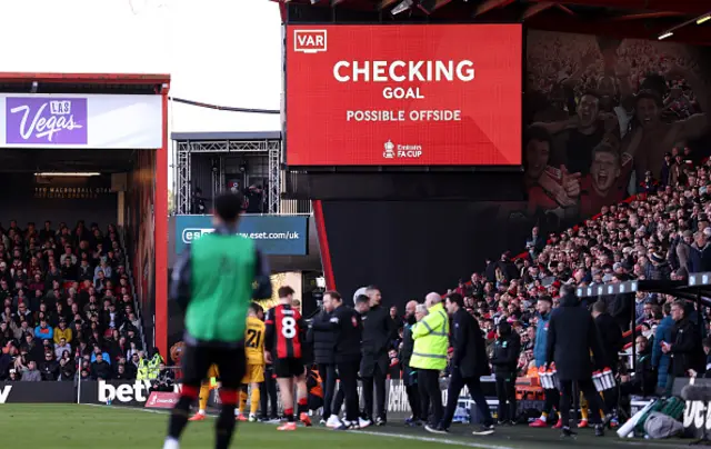 The LED screen displays a message from VAR which reads "Checking Goal, possible Handball"