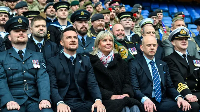 Rangers chairman Fraser Thornton (L) interim head coach Barry Ferguson (centre) and CEO Patrick Stewart (R) with members of the armed forces as part of Armed Forces Day before a William Hill Premiership match between Rangers and Motherwell at Ibrox Stadium