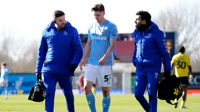 Jack Rudoni (centre) walks off the pitch