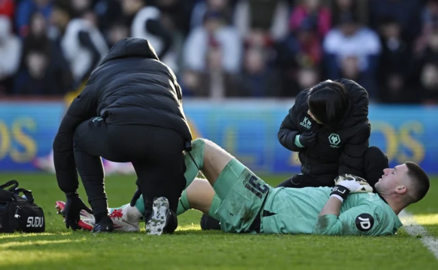 Wolverhampton Wanderers' Sam Johnstone receives medical attention