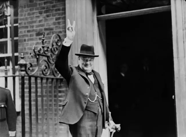 Prime Minister Winston Churchill outside 10 Downing Street, gesturing his famous 'V for Victory' hand signal, London, June 1943