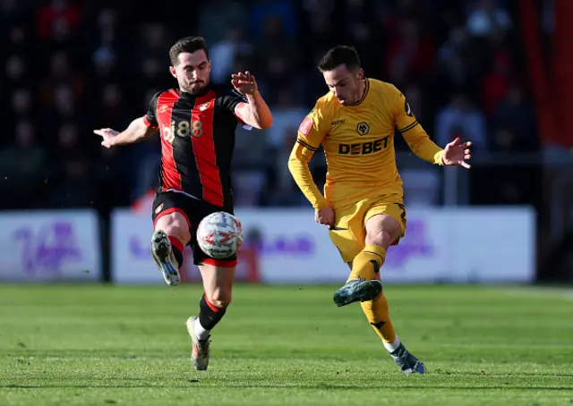 Pablo Sarabia of Wolverhampton Wanderers passes the ball under pressure from Lewis Cook