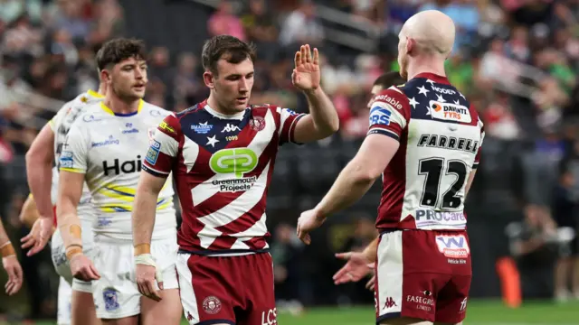 Wigan's Harry Smith and Liam Farrell celebrate a try