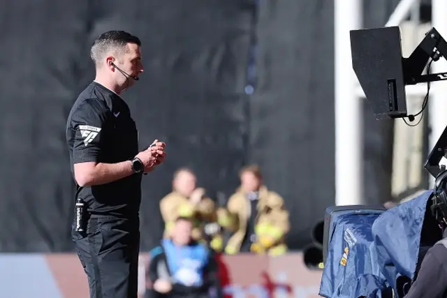 Referee Michael Oliver reviews the foul to the Jean-Philippe Mateta