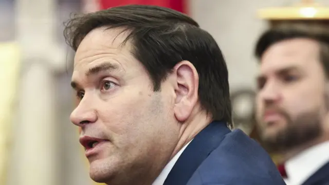 Marco Rubio is seen in up close, wearing a blue suit