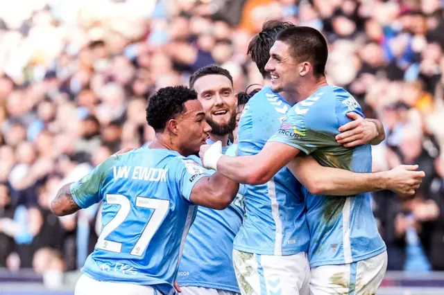 Bobby Thomas embraces a team-mate while celebrating a goal for Coventry