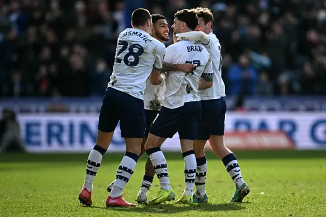 Robbie Brady (2R) is mobbed by teammates