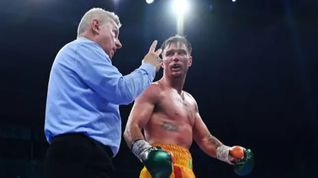 Referee Marcus McDonnell deducts a point from Donovan