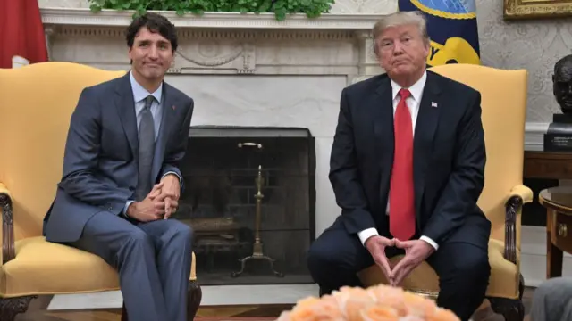 Justin Trudeau and Donald Trump sit in the Oval Office, both wear neutral expressions, and look slightly unimpressed