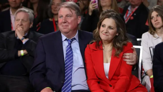 Former Deputy Prime Minister and Finance Minister Chrystia Freeland and her husband Graham Bowley, who are sitting next to each other, look on after it was announced Mark Carney had won the contest.