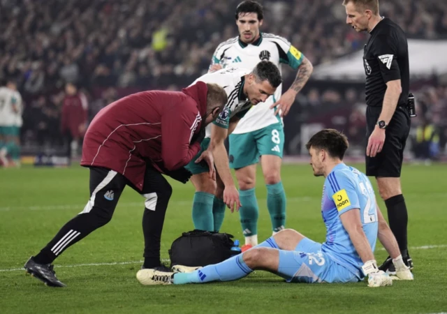 Newcastle United goalkeeper Nick Pope sits injured