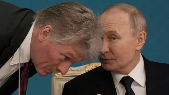 Kremlin spokesperson Dmitry Peskov speaks to Russian leader Vladimir Putin