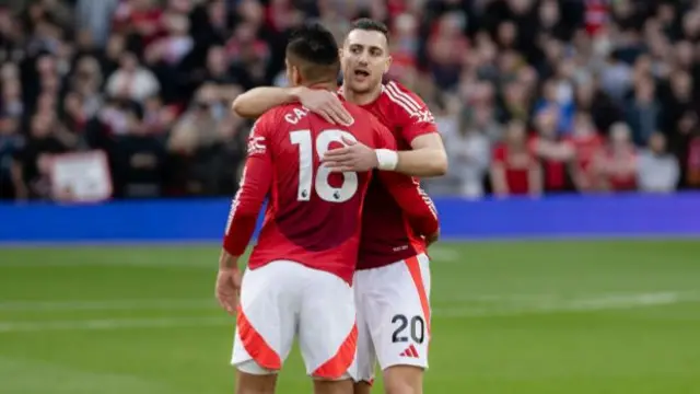 Diogo Dalot and Casemiro share a hug