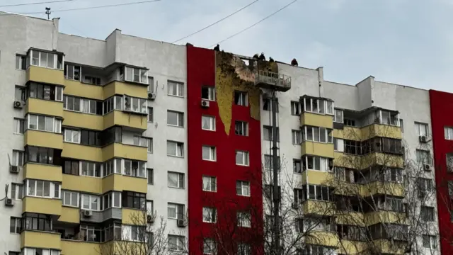 Damage to the upper part of a residential complex following a drone attack on Moscow.