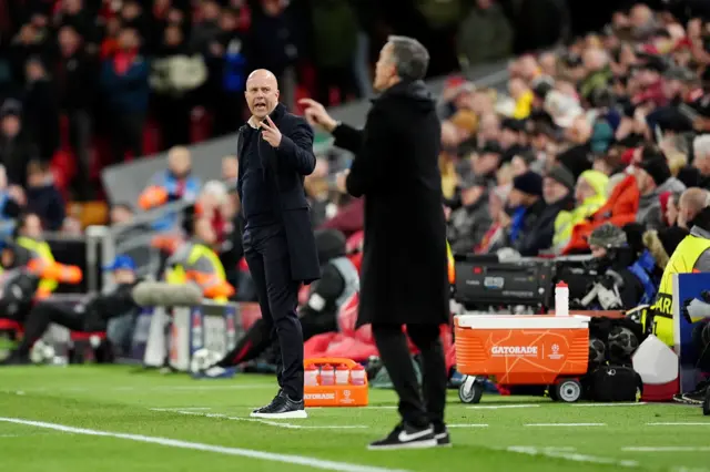 Liverpool manager Arne Slot (left) gestures on the touchline as Paris Saint-Germain head coach Luis Enrique watches on.