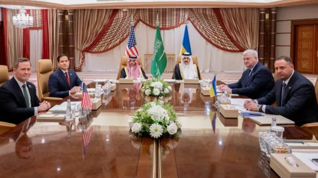 The US and Ukrainian delegations sit opposite each other at a large table, with Saudi representatives.