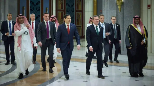 Marco Rubio and Mike Waltz walk, flanked by Saudi and US officials