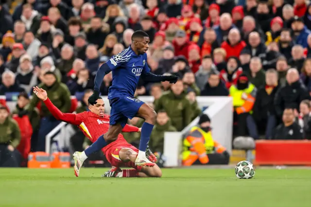 Trent Alexander-Arnold of Liverpool FC and Dembele battle.