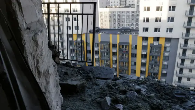 A damaged apartment balcony, with rubble, after a drone attack in Moscow.