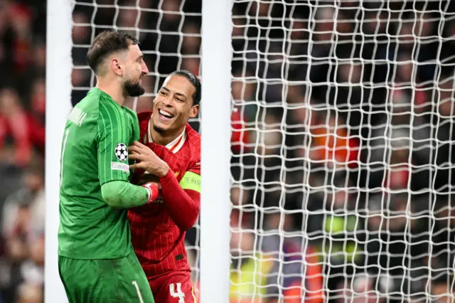 Paris Saint-Germain's Italian goalkeeper #01 Gianluigi Donnarumma (L) laughs with Liverpool's Dutch defender #04 Virgil van Dijk.