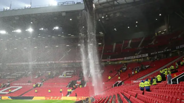 A general view as the drainage pipe in the roofs of the Sir Alex Ferguson Stand and East Stand leaks and pours onto the seats below following heavy rainfall