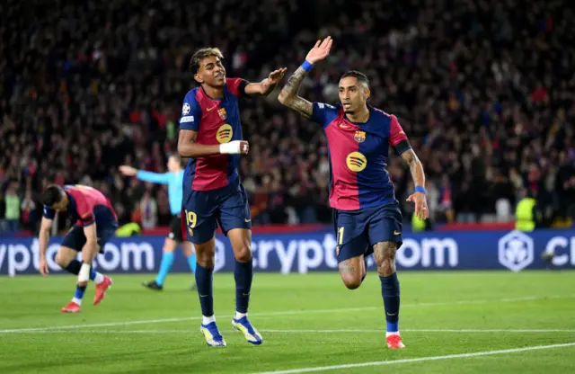 Raphinha of FC Barcelona celebrates scoring his team's third goal with teammate Lamine Yamal.