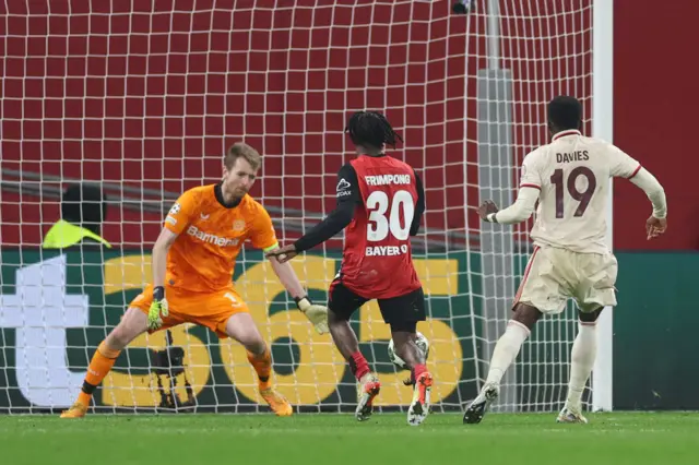 Alphonso Davies of Bayern Munich (R) scores his team's second goal.