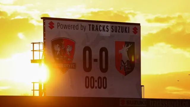 Exeter City scoreboard with the sunset in the background