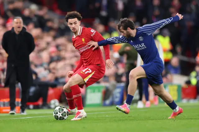 Curtis Jones of Liverpool in action with Khvicha Kvaratskhelia of Paris Saint Germain.