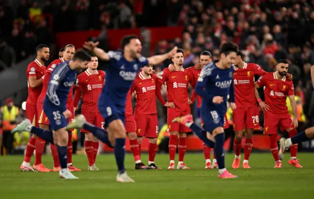 PSG players celebrate beating Liverpool on penalties