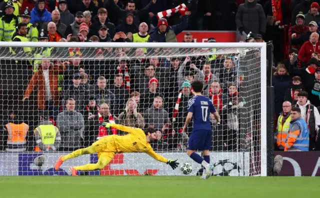 Vitinha of Paris Saint-Germain scores the team's first penalty in the penalty shootout past Alisson Becker