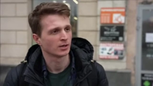 A man wearing a puffer jacket standing in the street