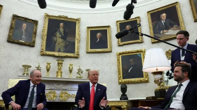 U.S. President Donald Trump gestures during a meeting with Irish Taoiseach (Prime Minister) Micheal Martin, with U.S. Vice President JD Vance sitting near them, in the Oval Office at the White House in Washington, D.C., U.S., March 12, 2025