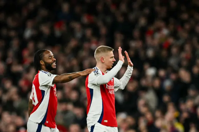 Oleksandr Zinchenko (R) celebrates with Arsenal's English striker #30 Raheem Sterling.