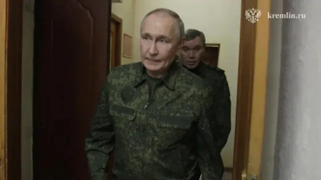 Putin walks through a doorway