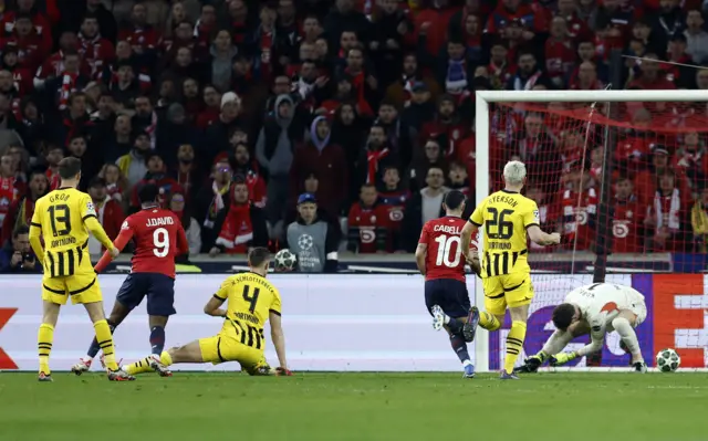Lille's Jonathan David scores their first goal.
