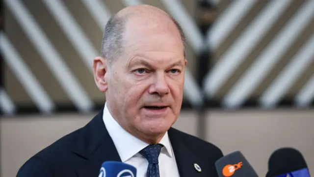 Olaf Scholz speaks to reporters this month