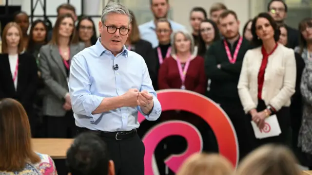 Starmer taps his hands together for emphasis at the Reckitt campus in Hull.