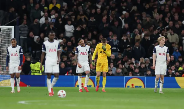 Tottenham Hotspur's Cristian Romero and teammates look dejected