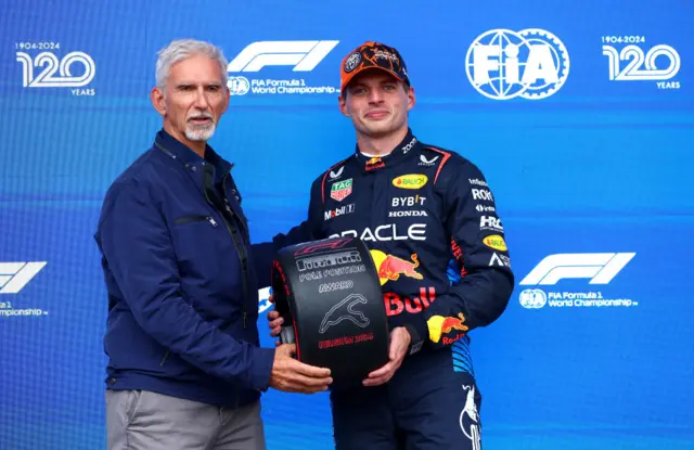 Damon Hill presents Max Verstappen with his pole position award at the 2024 Belgian Grand Prix